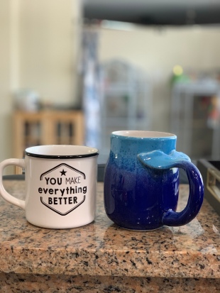A mug he bought for me for mother's day, and the one he adores from our honeymoon.